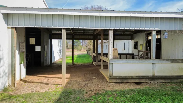a view of a lake with a big yard and large trees
