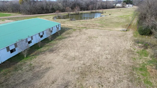 a green field with some trees in the background