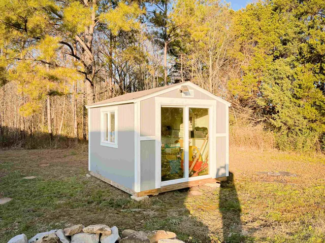 a living room with furniture a flat screen tv and a dining table