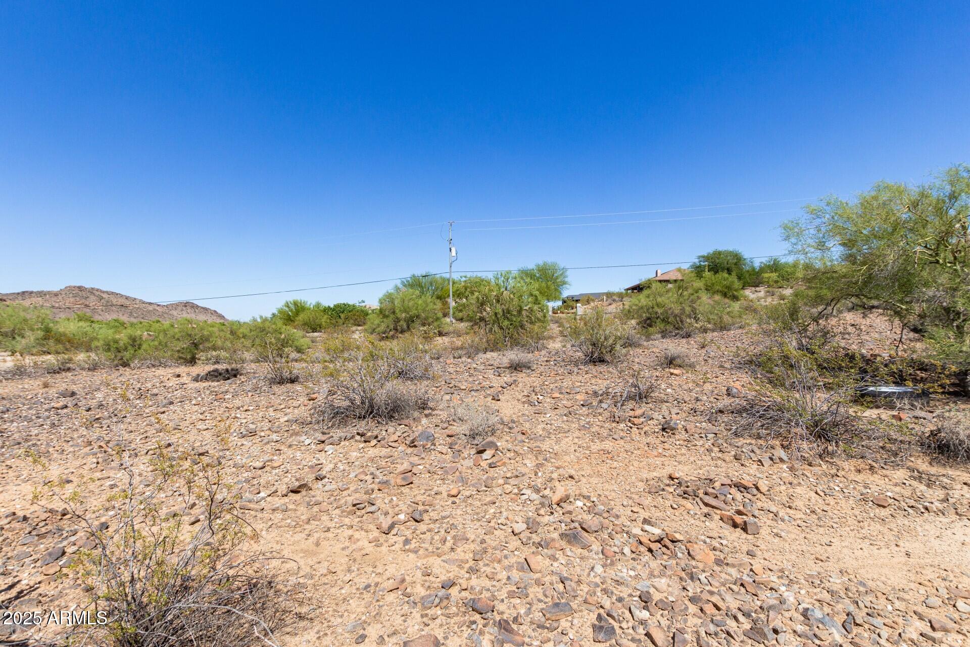9303 West Briles Road, Unit 4 Peoria, AZ 85383 - Photo 6 of 20 a view of a dry yard with mountains in the background