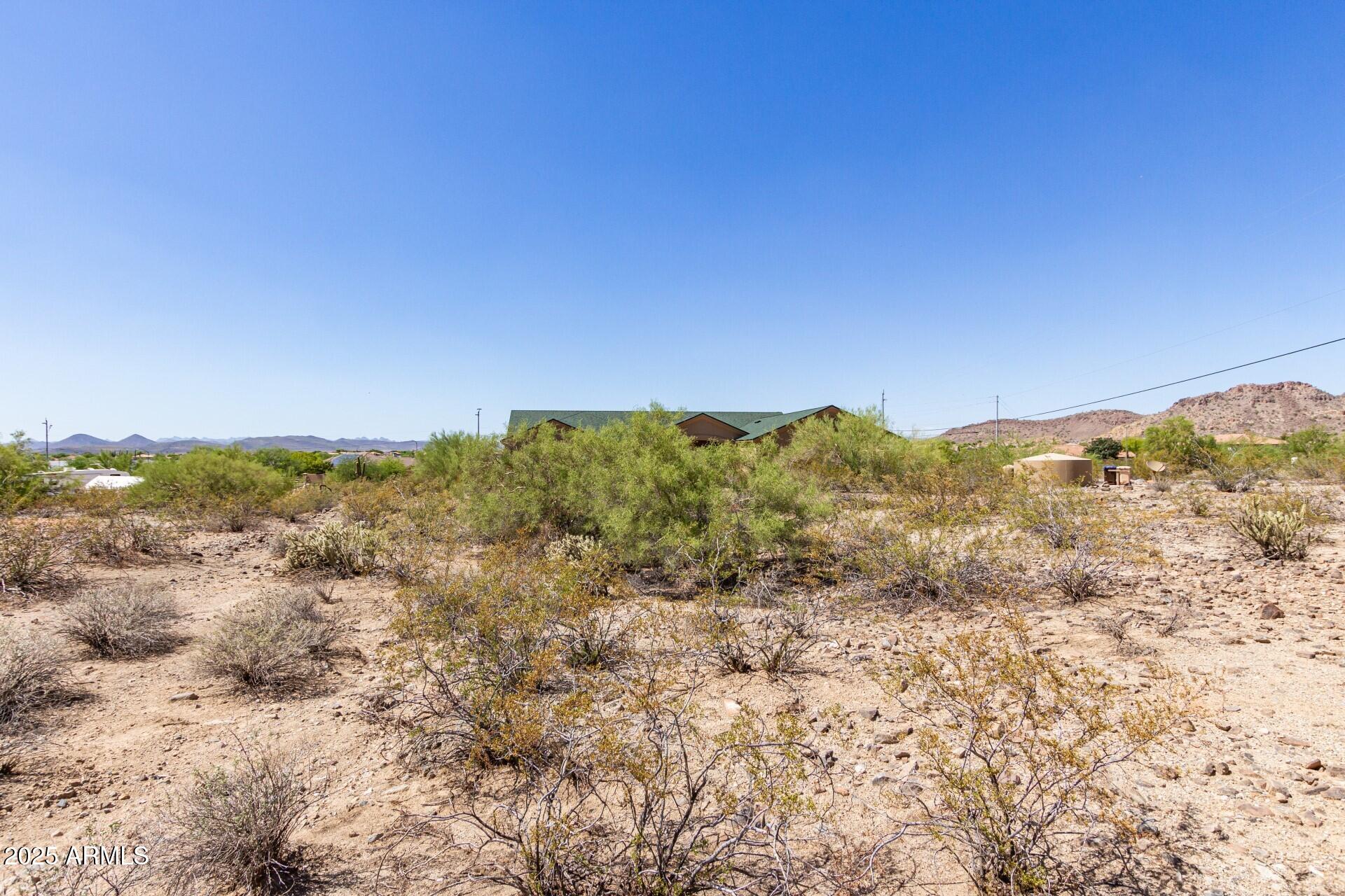 9303 West Briles Road, Unit 4 Peoria, AZ 85383 - Photo 9 of 20 a view of a large building with mountains in the background