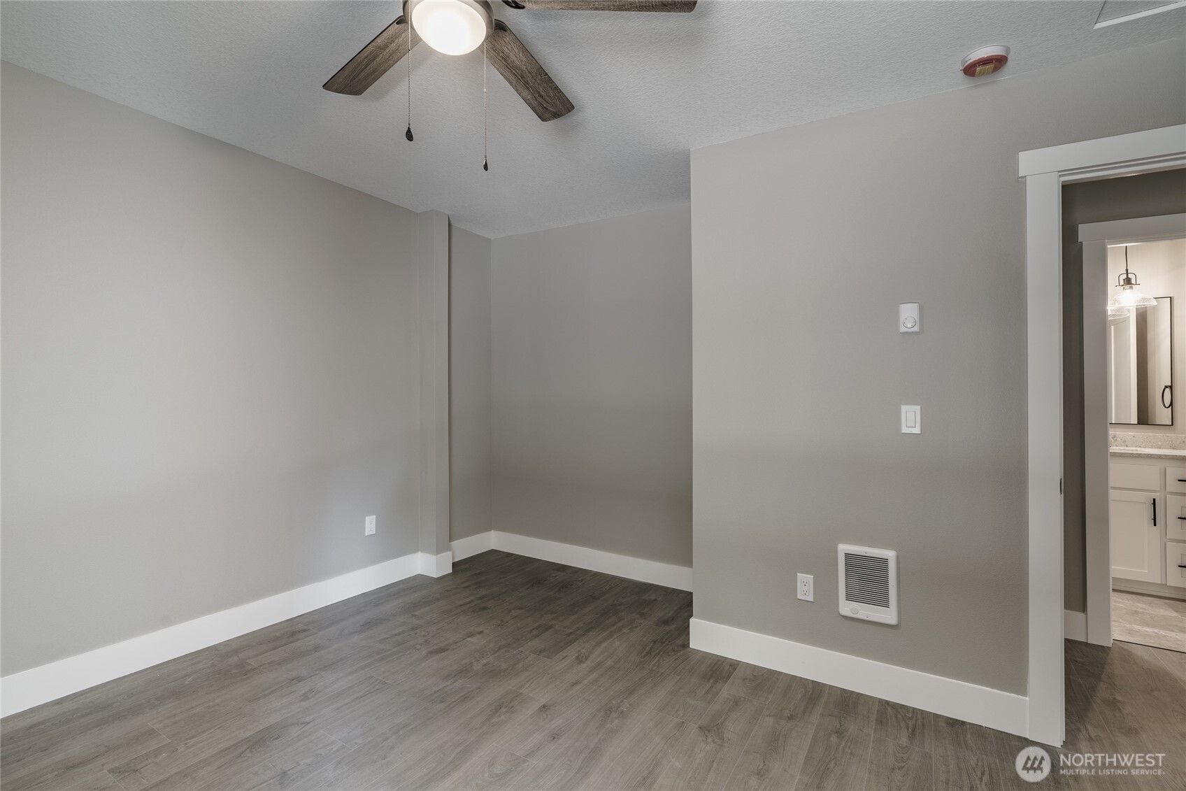 117 7th Street Southwest Long Beach, WA 98631 - Photo 13 of 25 wooden floor in an empty room with a window