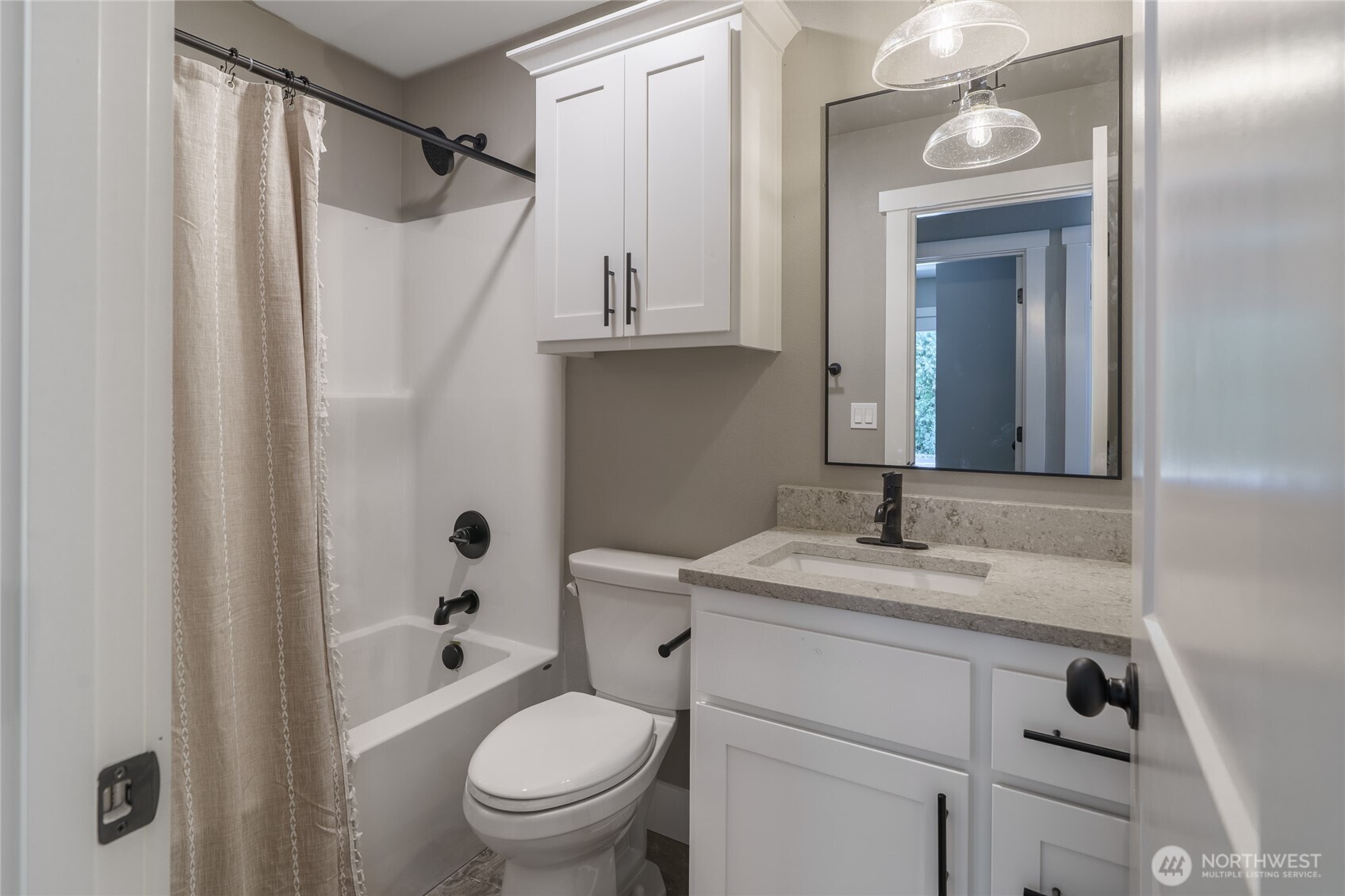 117 7th Street Southwest Long Beach, WA 98631 - Photo 16 of 25 a bathroom with a granite countertop sink toilet and shower