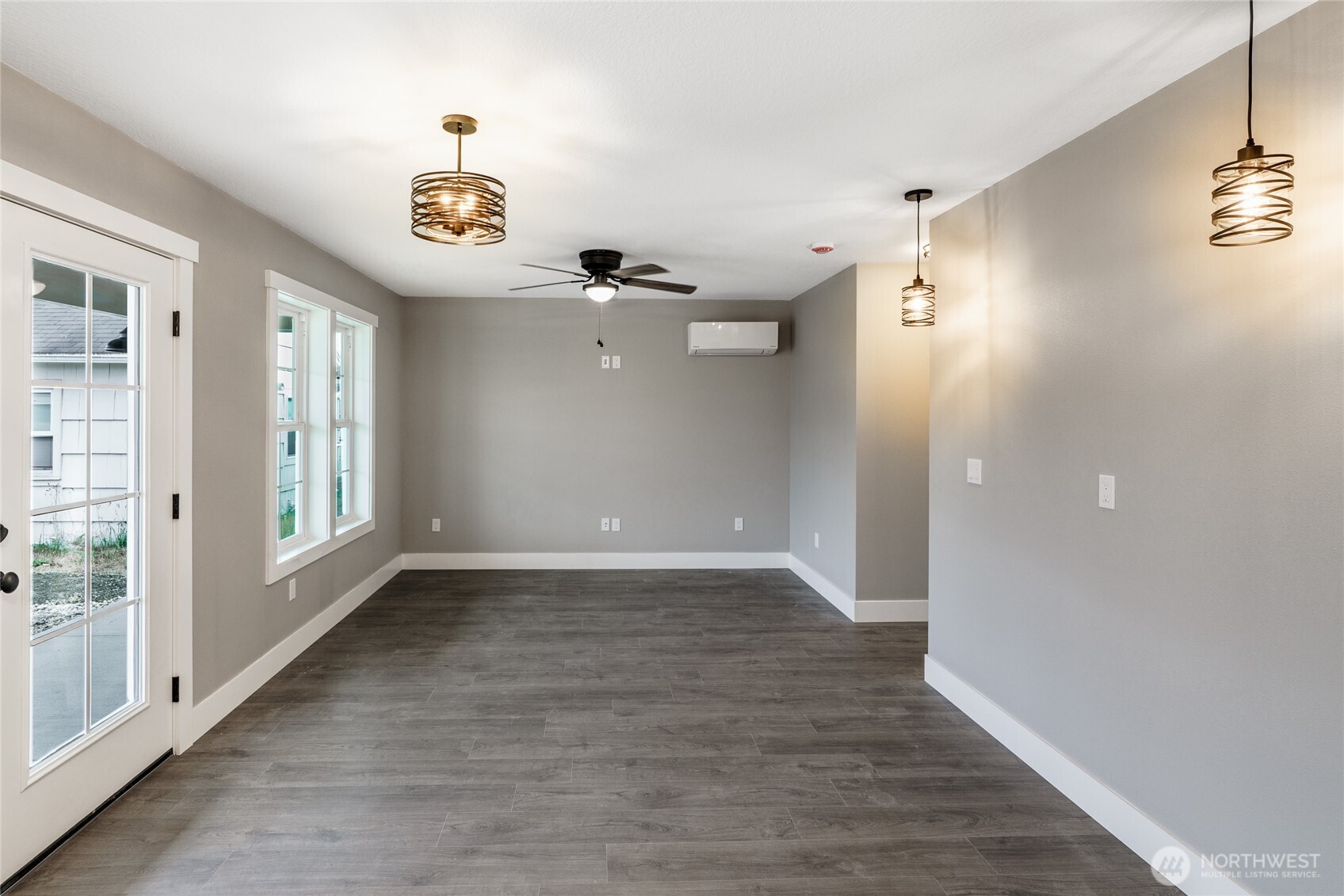 117 7th Street Southwest Long Beach, WA 98631 - Photo 5 of 25 wooden floor in an empty room with a window
