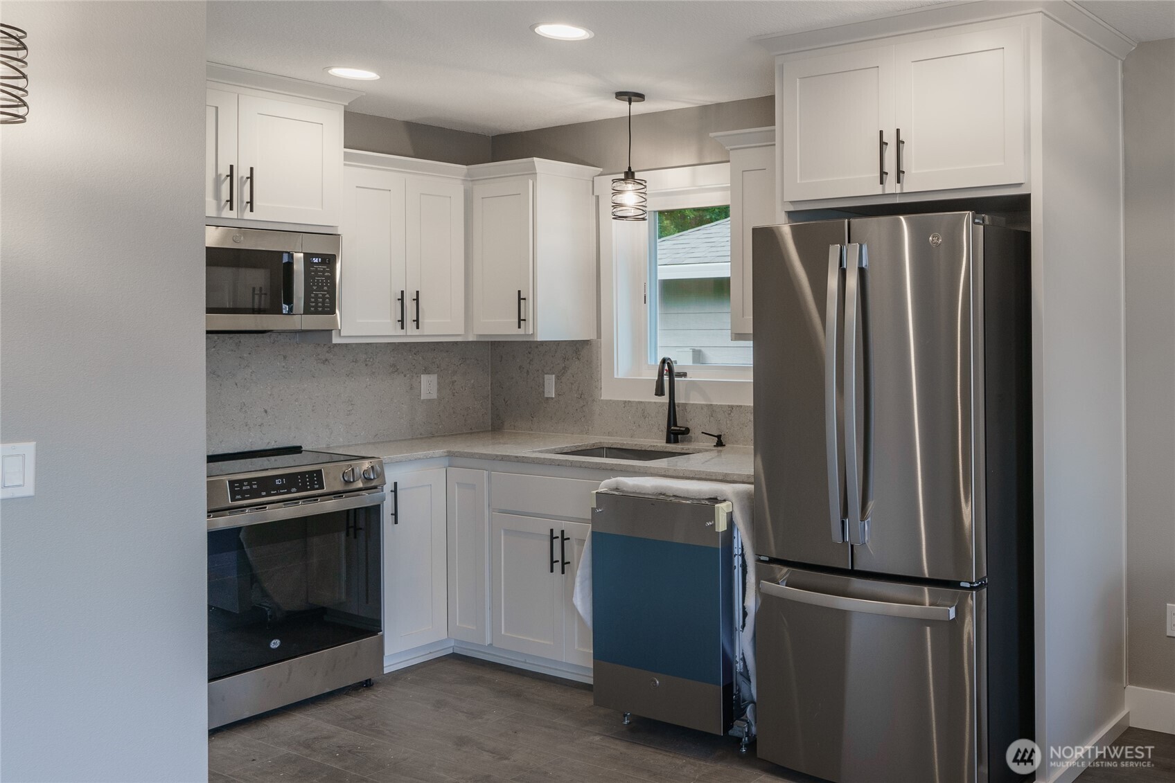 117 7th Street Southwest Long Beach, WA 98631 - Photo 8 of 25 a kitchen with stainless steel appliances granite countertop a refrigerator and a stove top oven