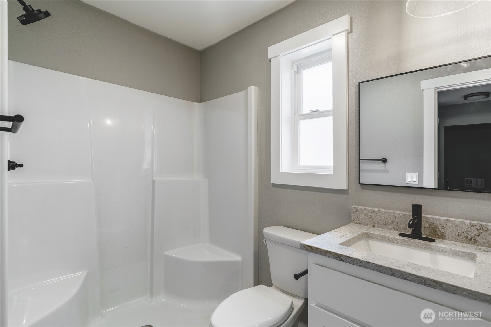 117 7th Street Southwest Long Beach, WA 98631 - Photo 9 of 25 a bathroom with a granite countertop sink toilet a mirror and bathtub