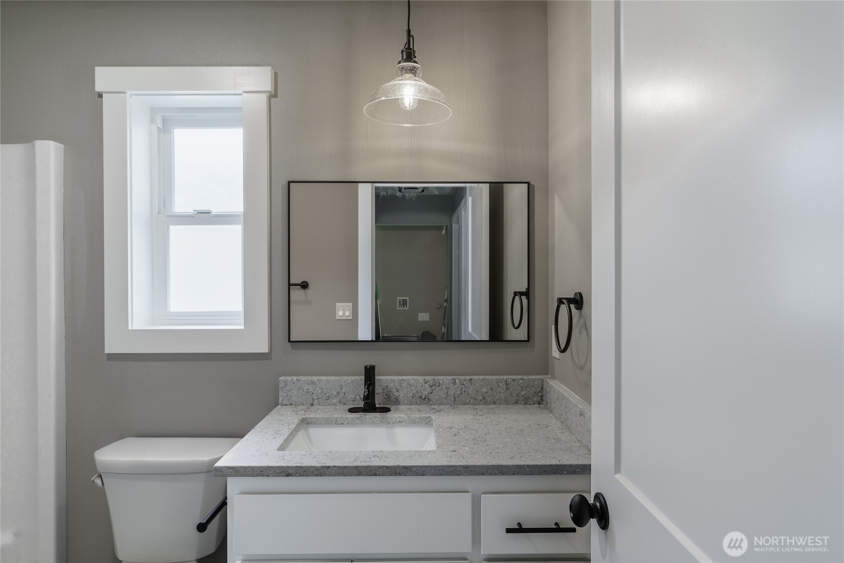 117 7th Street Southwest Long Beach, WA 98631 - Photo 10 of 25 a bathroom with a toilet sink and mirror