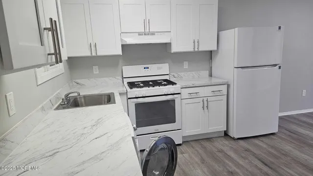 a kitchen with a stove top oven sink and cabinets