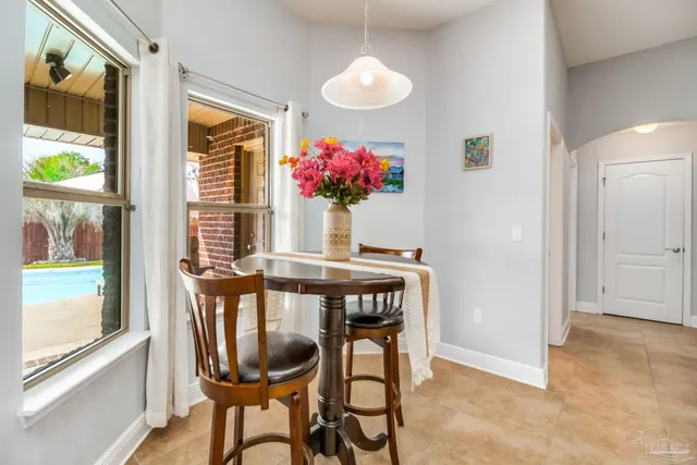 a view of a dining room with furniture and a window