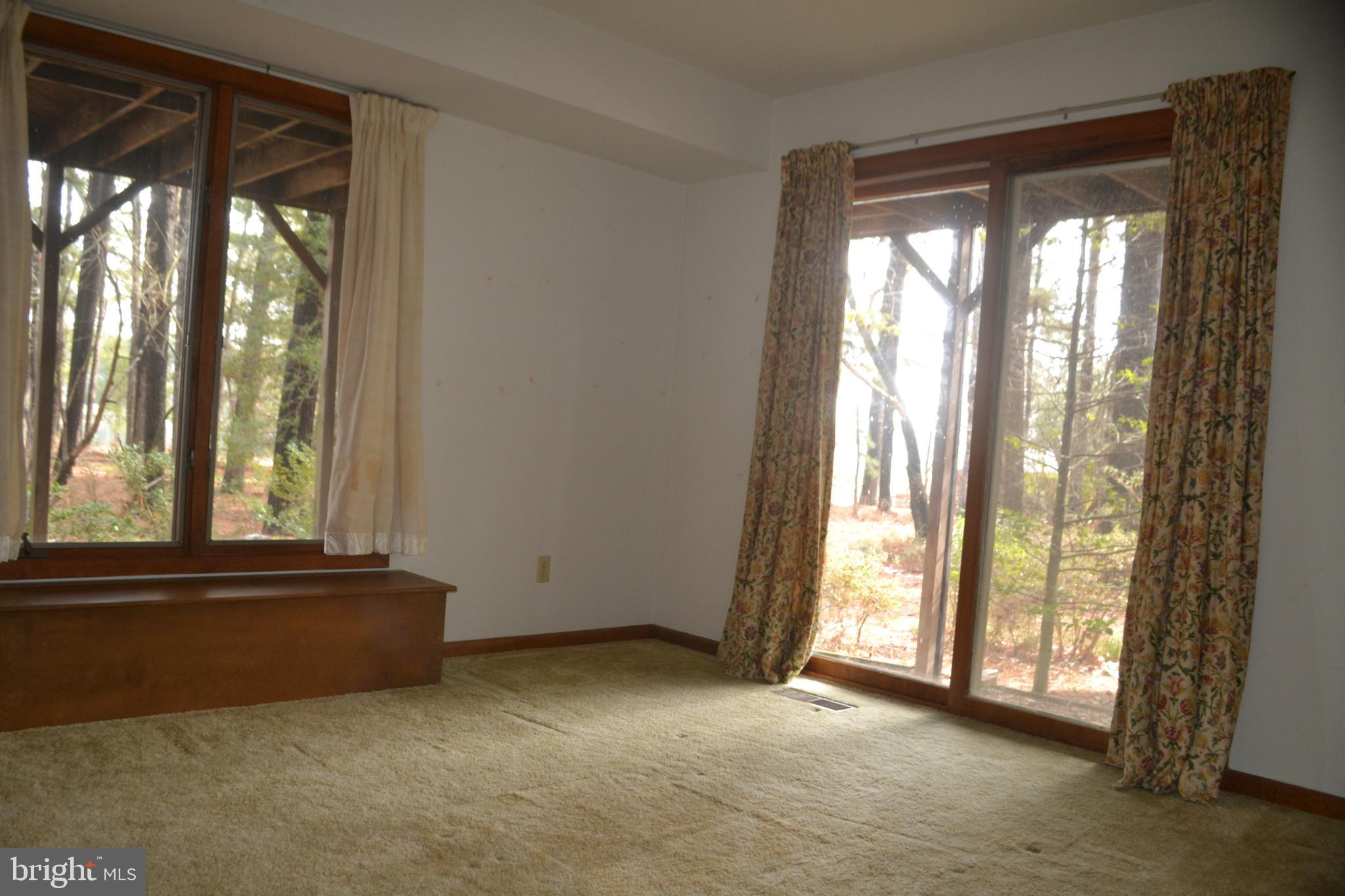 7223 Drum Point Road St. Michaels, MD 21663 - Photo 20 of 38 an empty room with windows and view of balcony