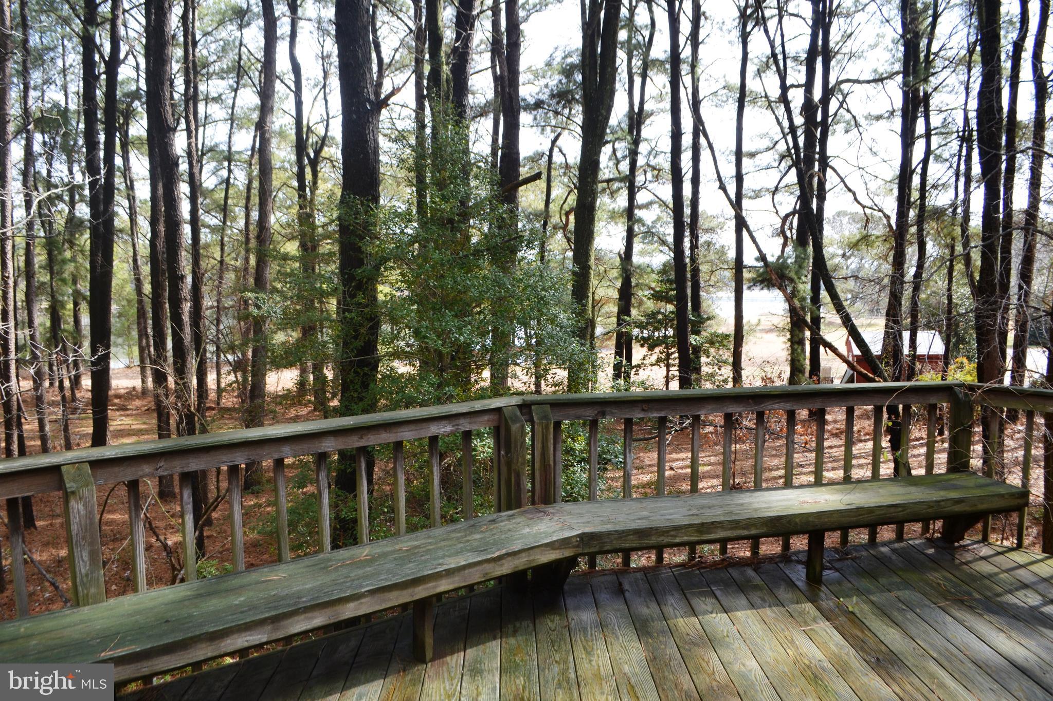 7223 Drum Point Road St. Michaels, MD 21663 - Photo 34 of 38 a view of a roof deck with wooden floor and fence