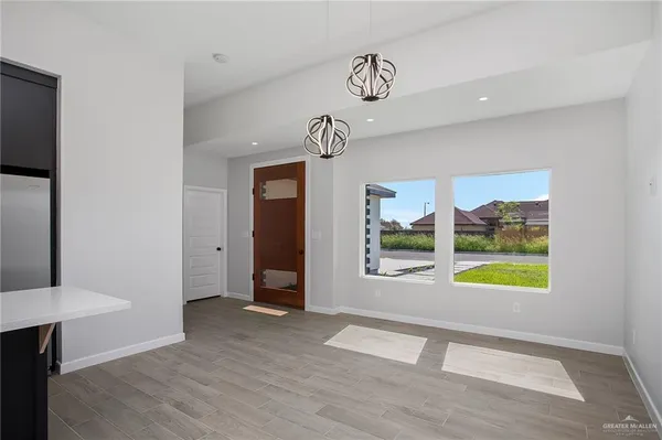 a view of an entryway with wooden floor