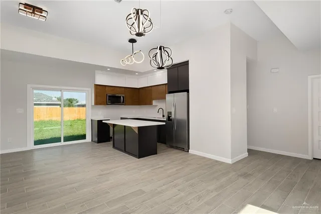 a large kitchen with a large window a counter space and stainless steel appliances