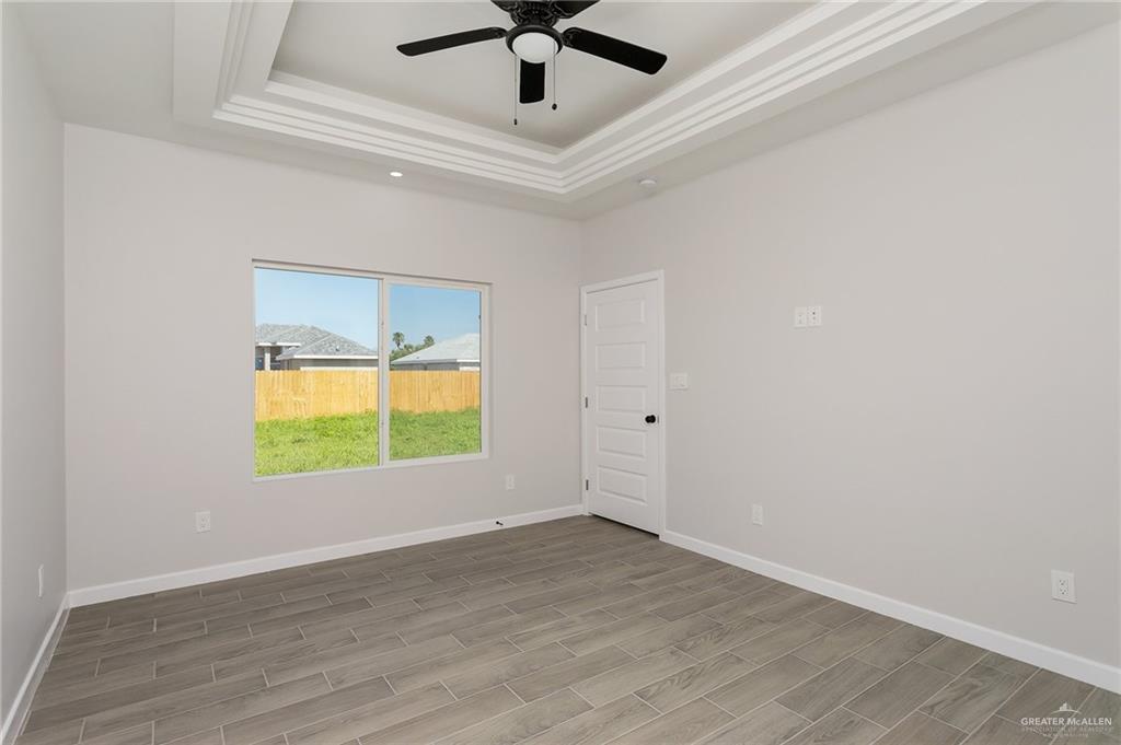2302 San Pascual Street San Juan, TX 78589 - Photo 7 of 13 an empty room with window and a ceiling fan