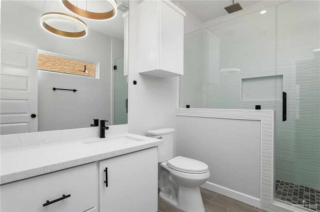 2302 San Pascual Street San Juan, TX 78589 - Photo 8 of 13 a bathroom with a sink a toilet and shower