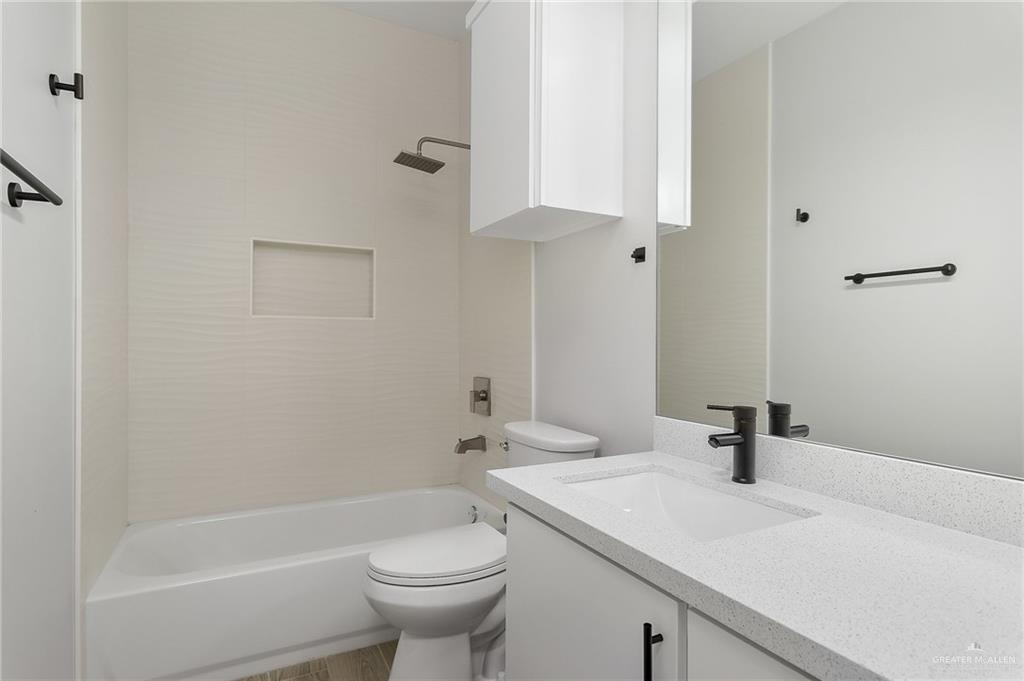 2302 San Pascual Street San Juan, TX 78589 - Photo 10 of 13 a bathroom with a sink a toilet and shower