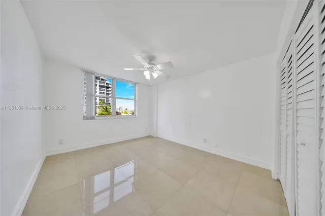 a view of empty room with ceiling fan