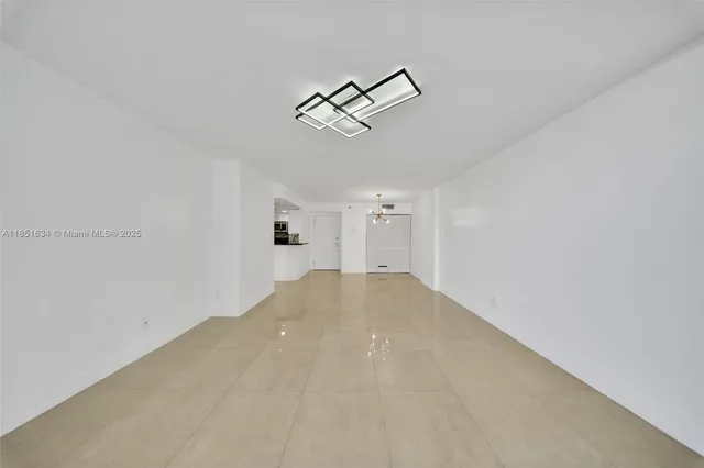 a front view of a building with a garden and plants