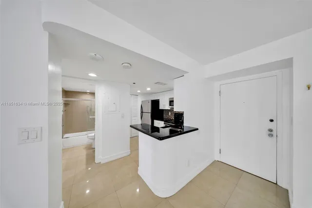 a kitchen with a refrigerator stove and microwave