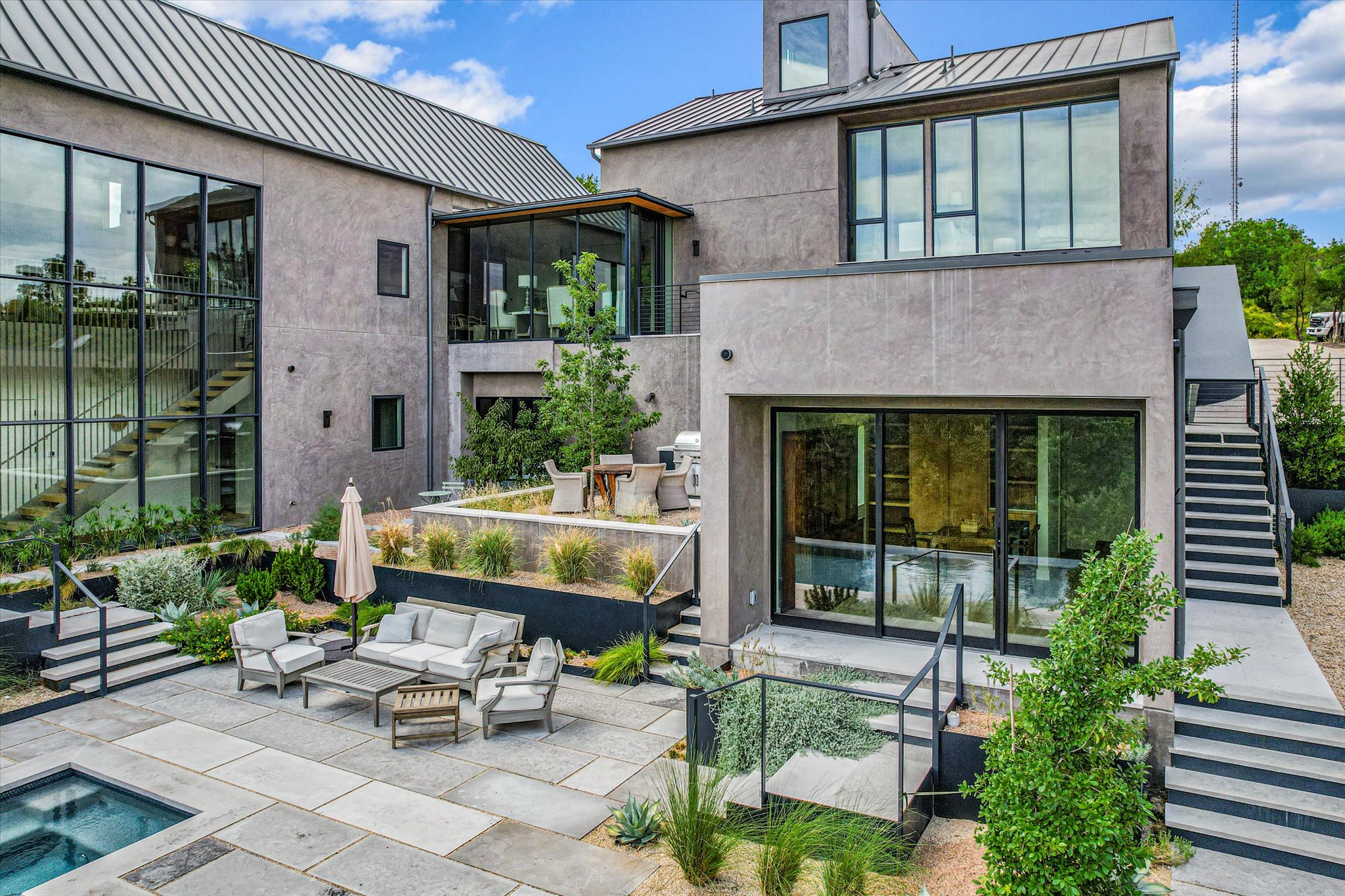 2405 Deer Pass Austin, TX 78746 - Photo 28 of 28 Rear view of property with stairway, a standing seam roof, a patio area, and an outdoor living space