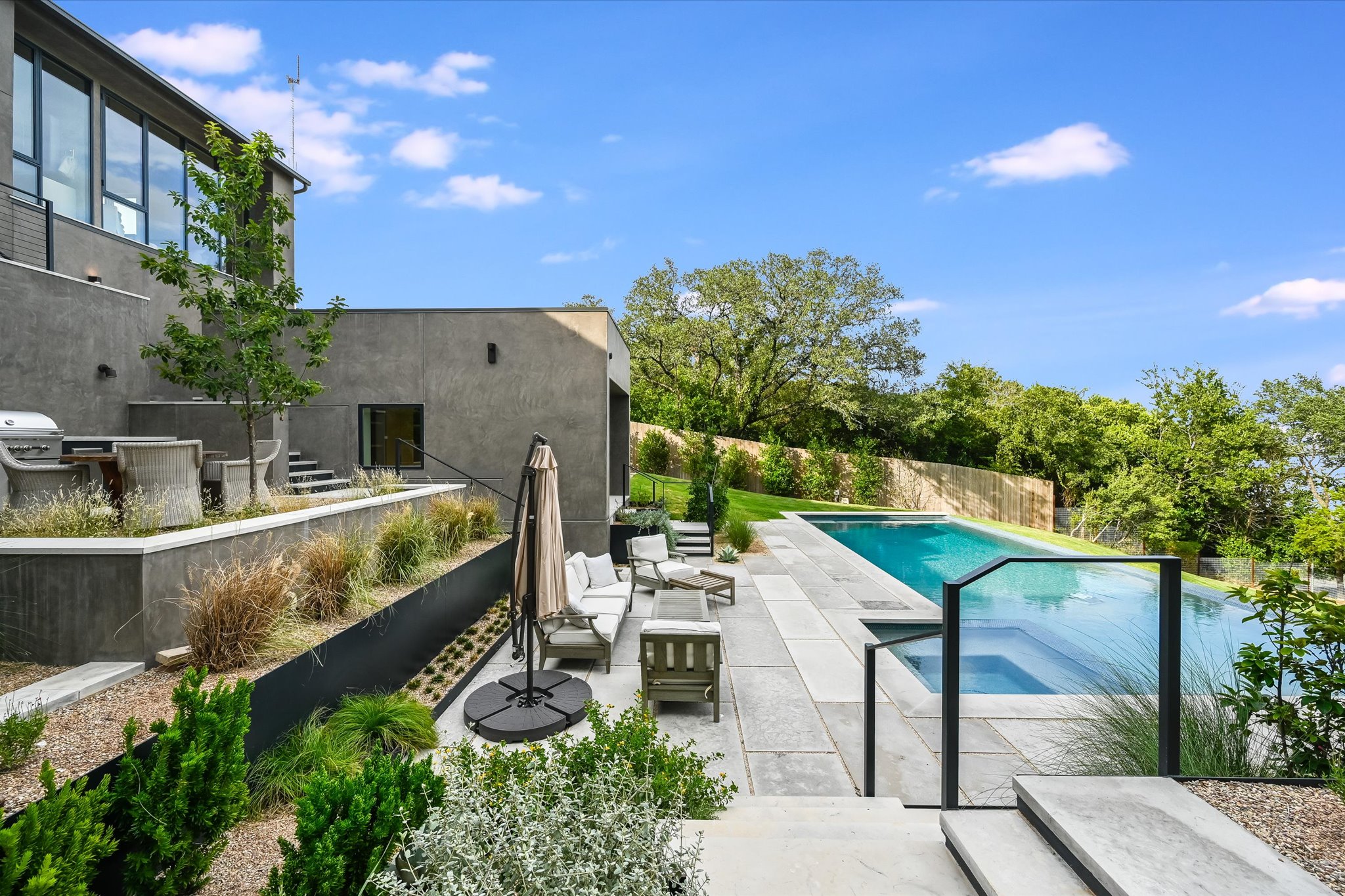 2405 Deer Pass Austin, TX 78746 - Photo 28 of 38 View of pool with a patio area, a fenced backyard, an in-ground hot tub, and an outdoor living space