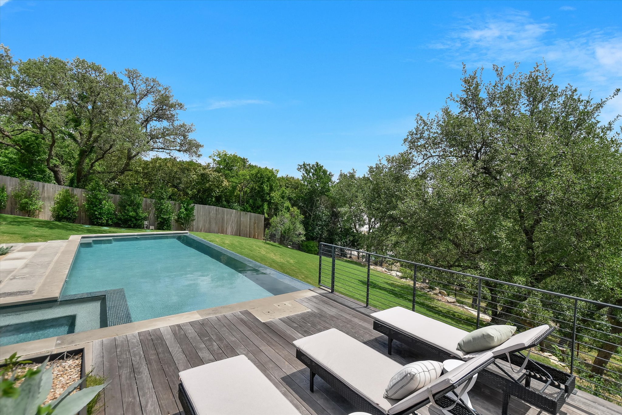 2405 Deer Pass Austin, TX 78746 - Photo 29 of 38 Rectangular swimming pool with integrated spa and stone coping