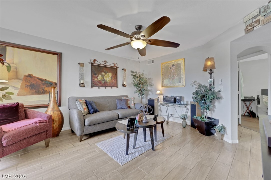 698 South Racetrack Road, Unit 1614 Henderson, NV 89015 - Photo 25 of 35 Well-lit living room with rich wooden flooring and an elegant ceiling fan.