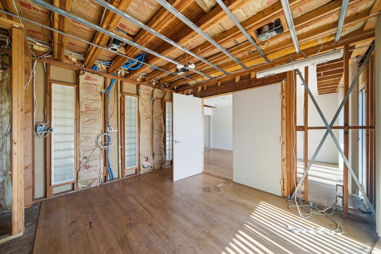 101 Round Hill Road Tiburon, CA 94920 - Photo 17 of 22 an empty room with wooden floor and windows