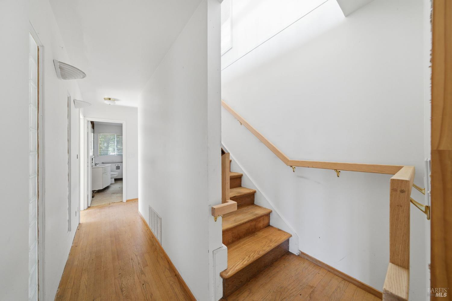 101 Round Hill Road Tiburon, CA 94920 - Photo 18 of 22 a view of a hallway with wooden floor and stairs