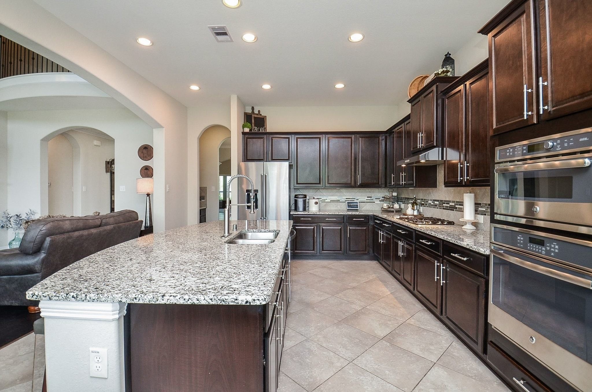 2714 Topaz Cove Lane Rosharon, TX 77583 - Photo 18 of 50 a kitchen with stainless steel appliances granite countertop a sink a stove and a refrigerator
