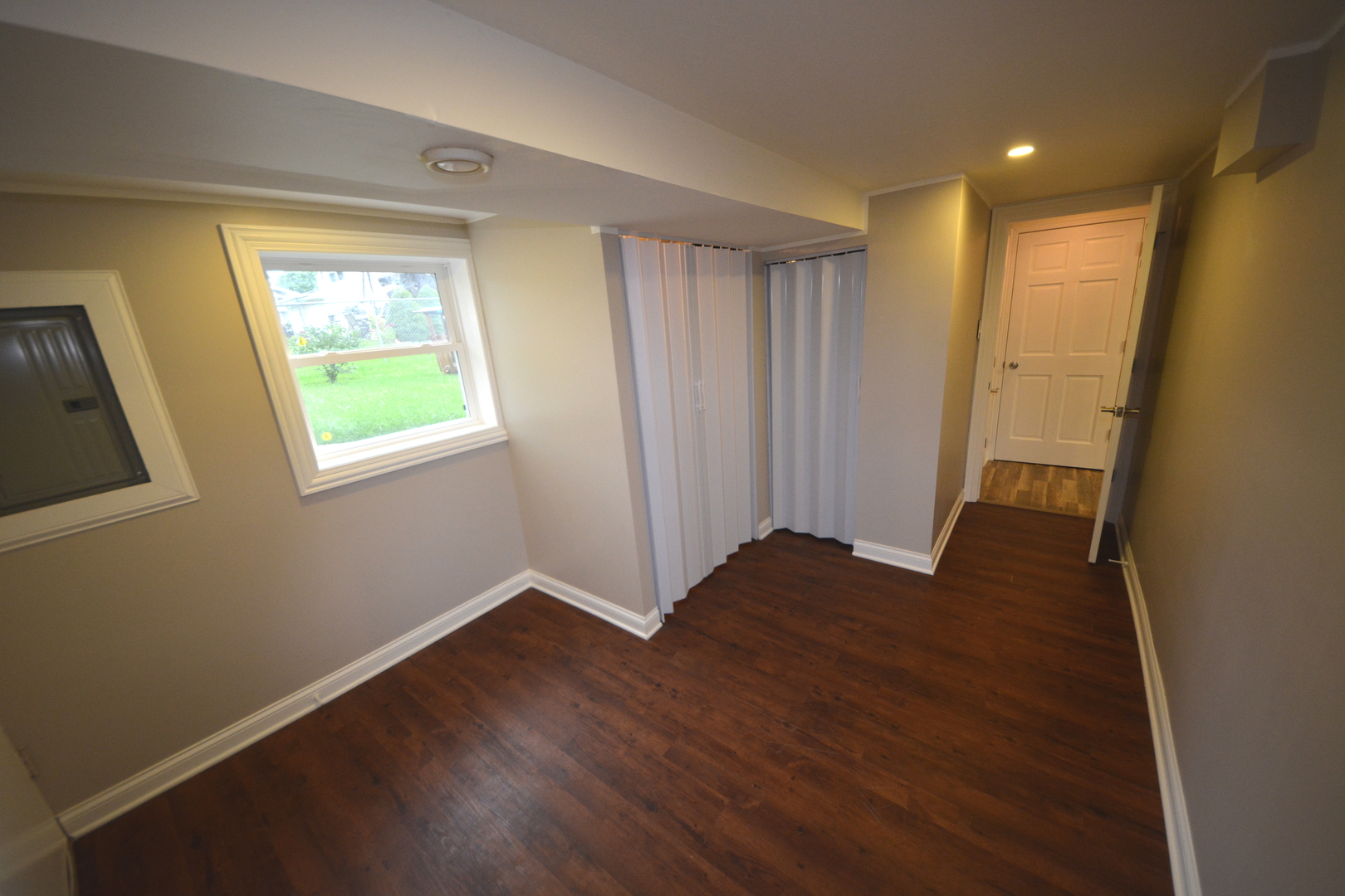 8029 West 90th Street Hickory Hills, IL 60457 - Photo 15 of 23 a view of an empty room with wooden floor and a window