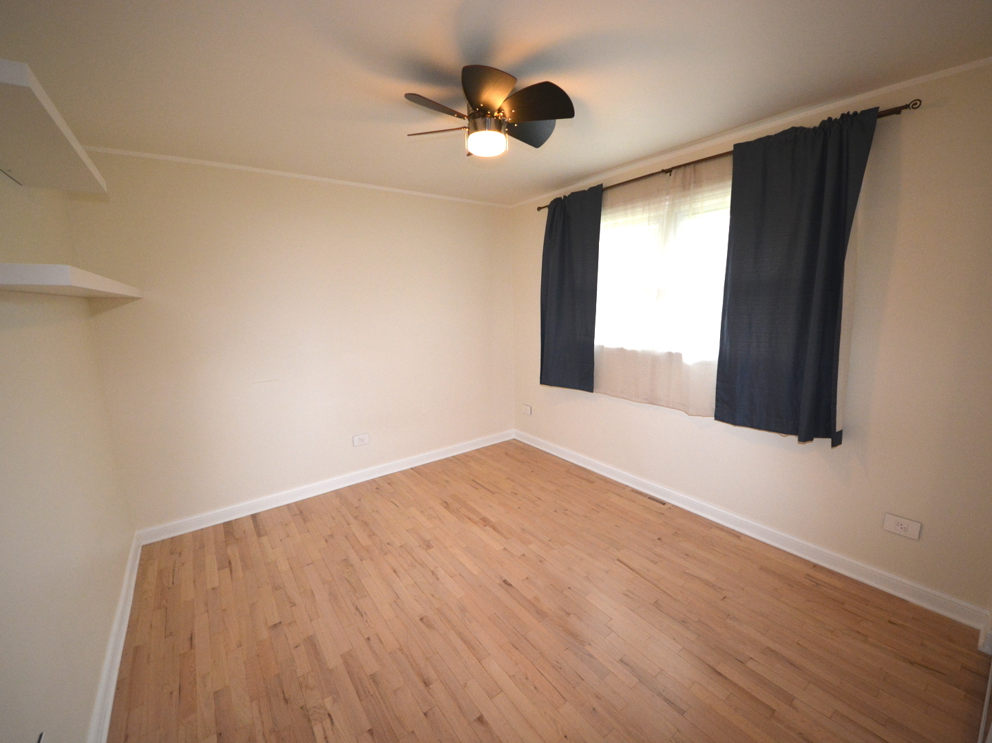 8029 West 90th Street Hickory Hills, IL 60457 - Photo 20 of 23 an empty room with wooden floor and windows