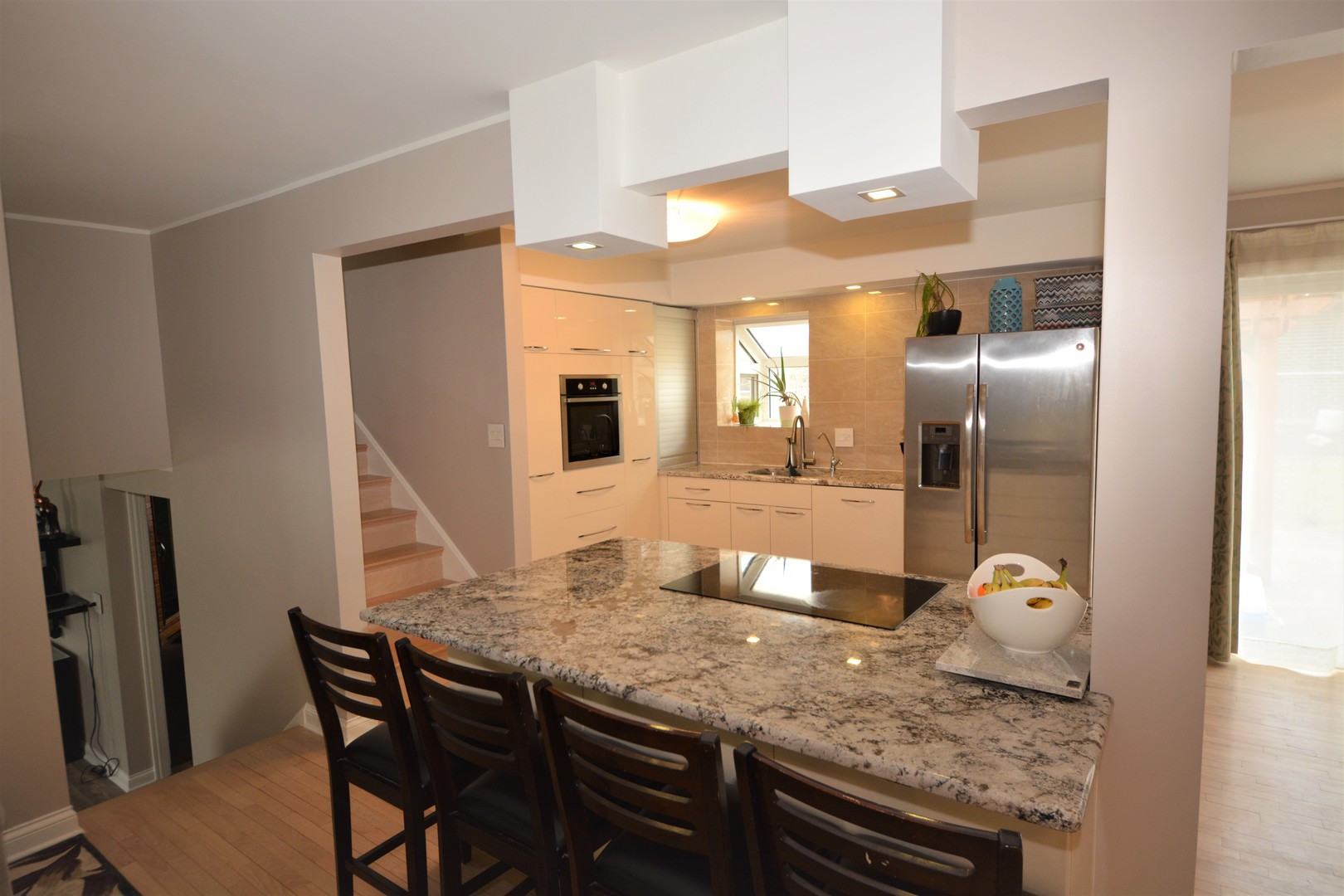 8029 West 90th Street Hickory Hills, IL 60457 - Photo 3 of 23 a kitchen with granite countertop stainless steel appliances and wooden floor