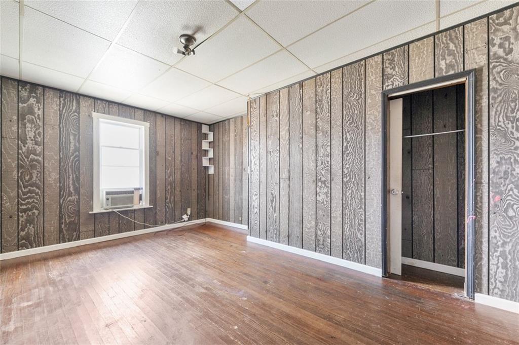 303 Agnew Road Jeannette, PA 15644 - Photo 14 of 28 a view of an empty room with wooden floor and a window