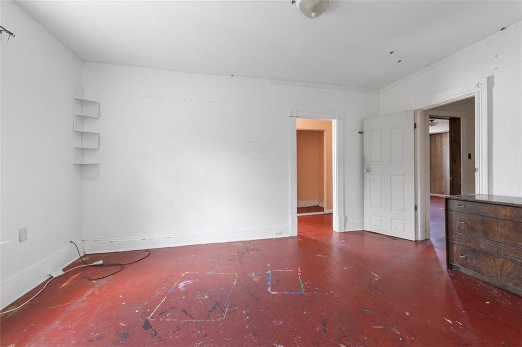 303 Agnew Road Jeannette, PA 15644 - Photo 20 of 28 a view of an empty room with wooden floor and a window