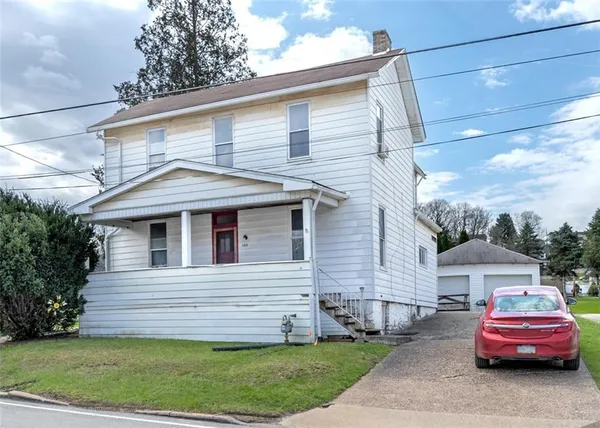a front view of a house with a garden