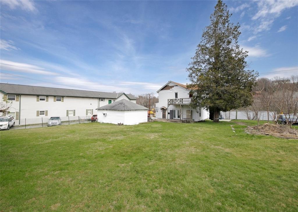 303 Agnew Road Jeannette, PA 15644 - Photo 28 of 28 a view of a house with a big yard and large trees