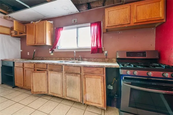 a kitchen with stainless steel appliances granite countertop a sink stove and cabinets