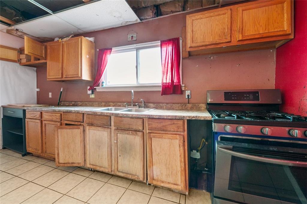 303 Agnew Road Jeannette, PA 15644 - Photo 9 of 28 a kitchen with stainless steel appliances granite countertop a sink stove and cabinets