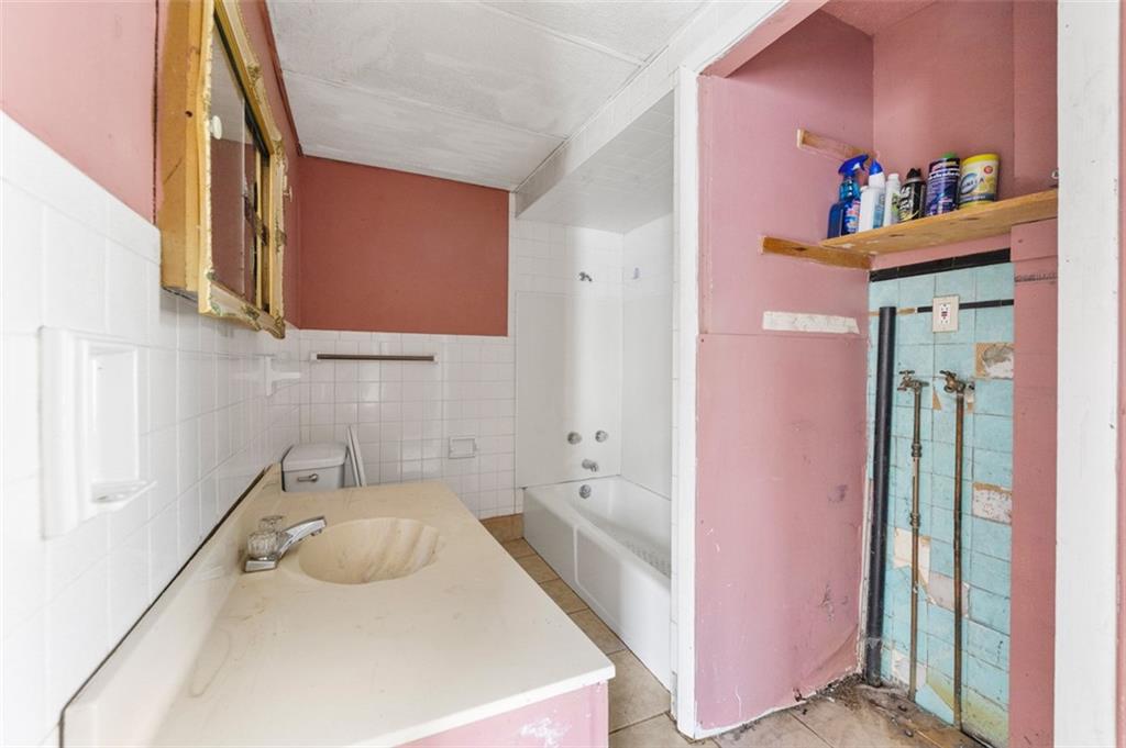 303 Agnew Road Jeannette, PA 15644 - Photo 10 of 28 a bathroom with a sink and a mirror