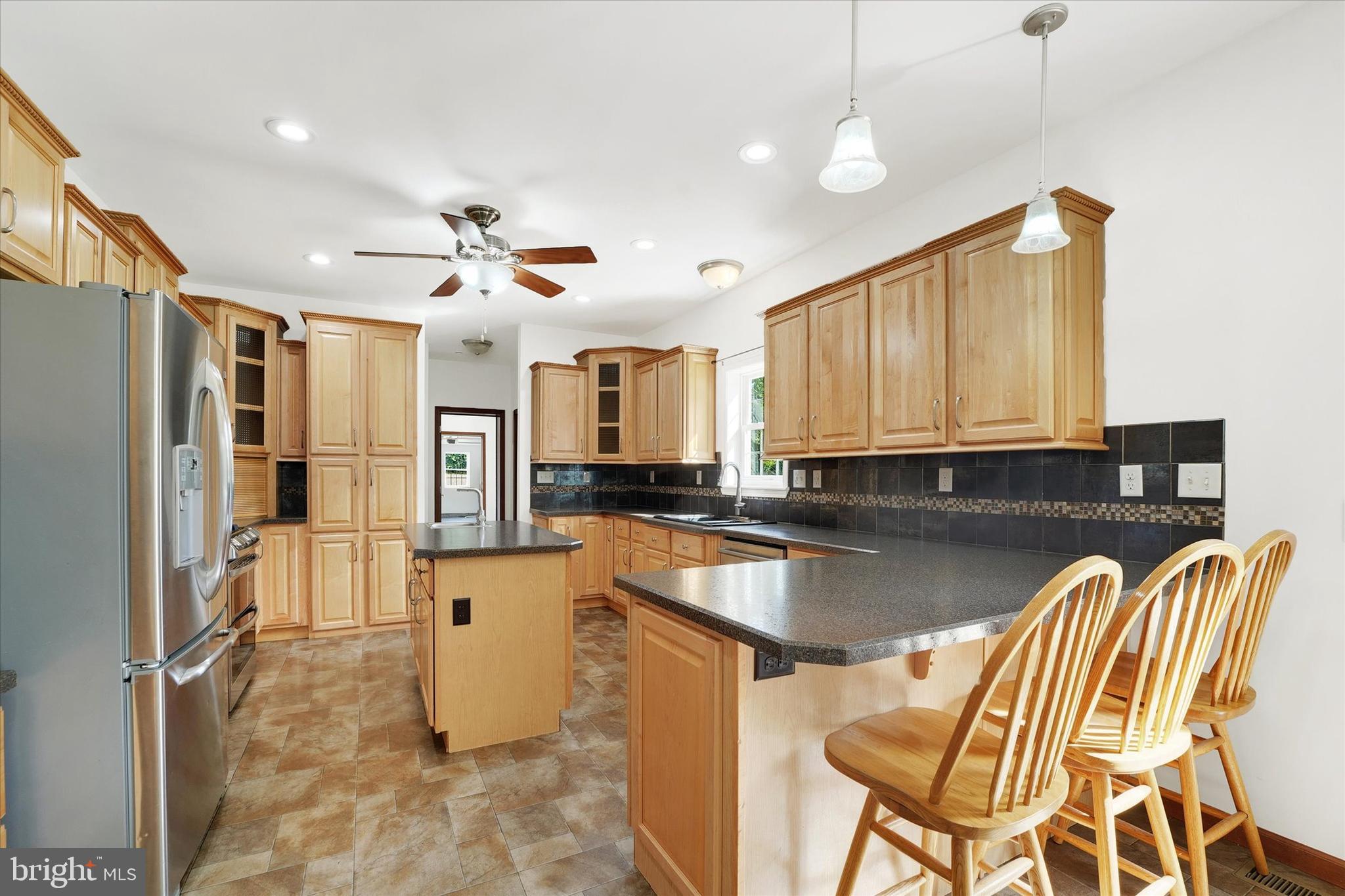 249 Floral Way Rising Sun, MD 21911 - Photo 28 of 65 a kitchen with a refrigerator sink and cabinets