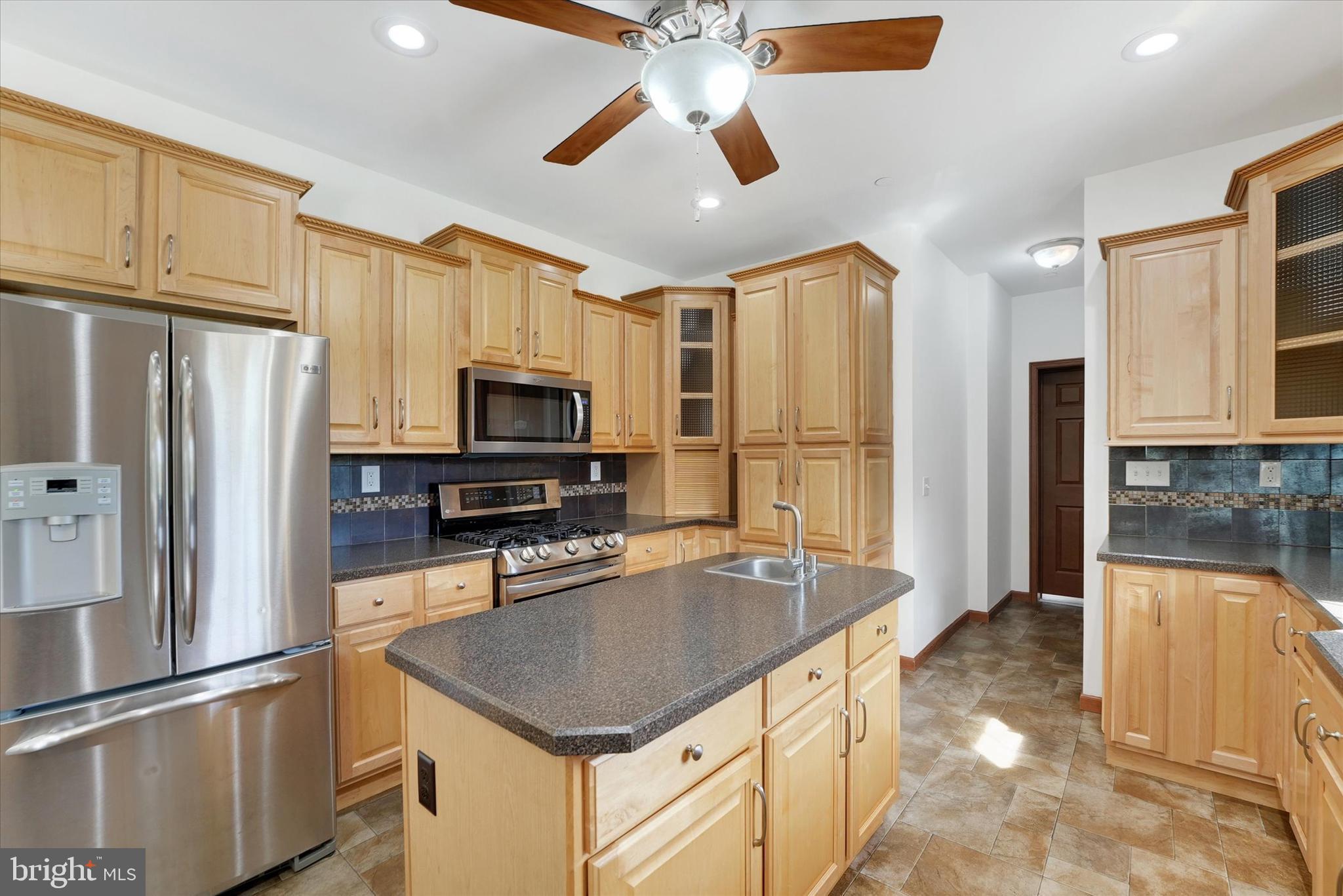 249 Floral Way Rising Sun, MD 21911 - Photo 31 of 65 a kitchen with stainless steel appliances granite countertop a refrigerator a stove and a sink