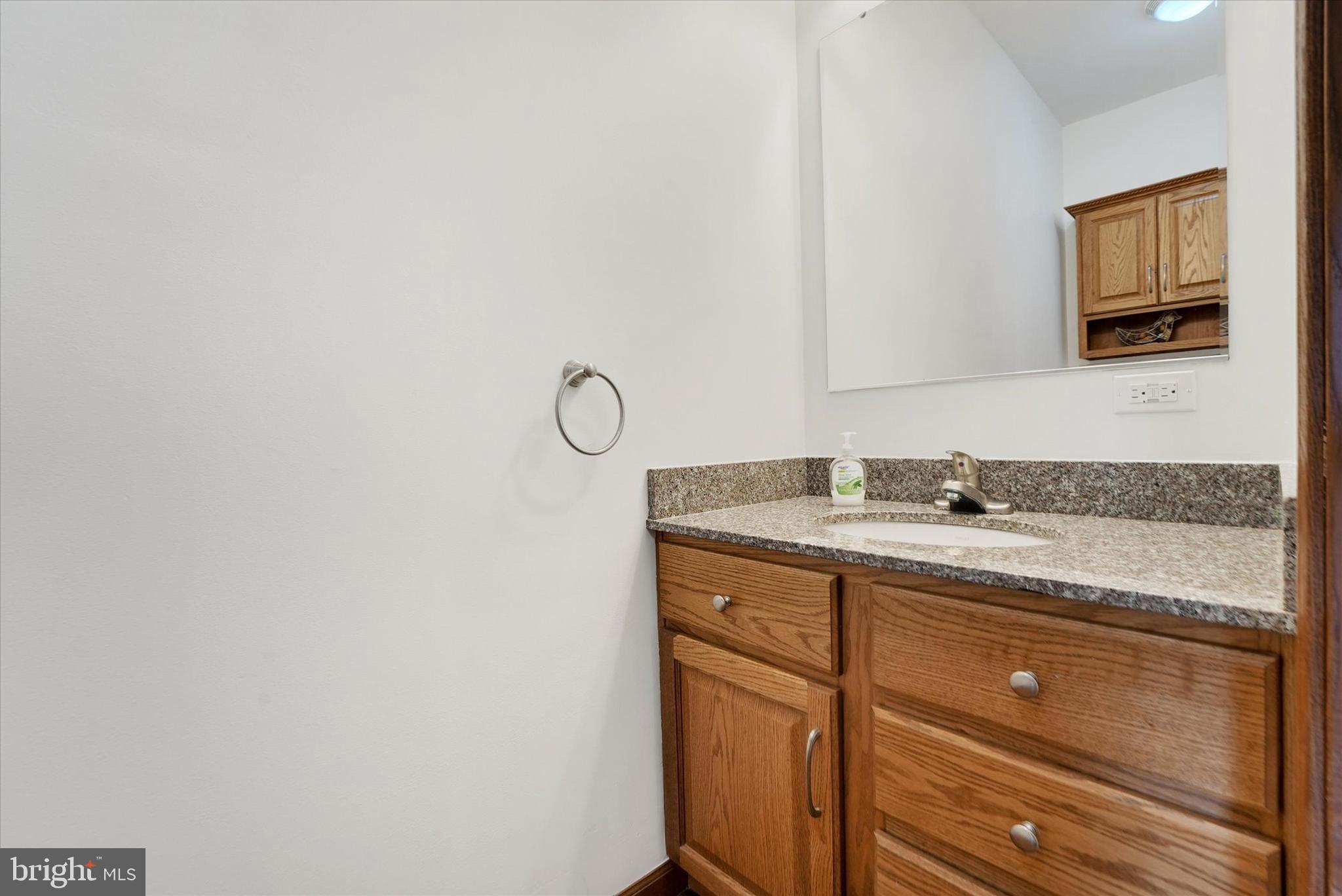 249 Floral Way Rising Sun, MD 21911 - Photo 36 of 65 a bathroom with a granite countertop sink and a mirror