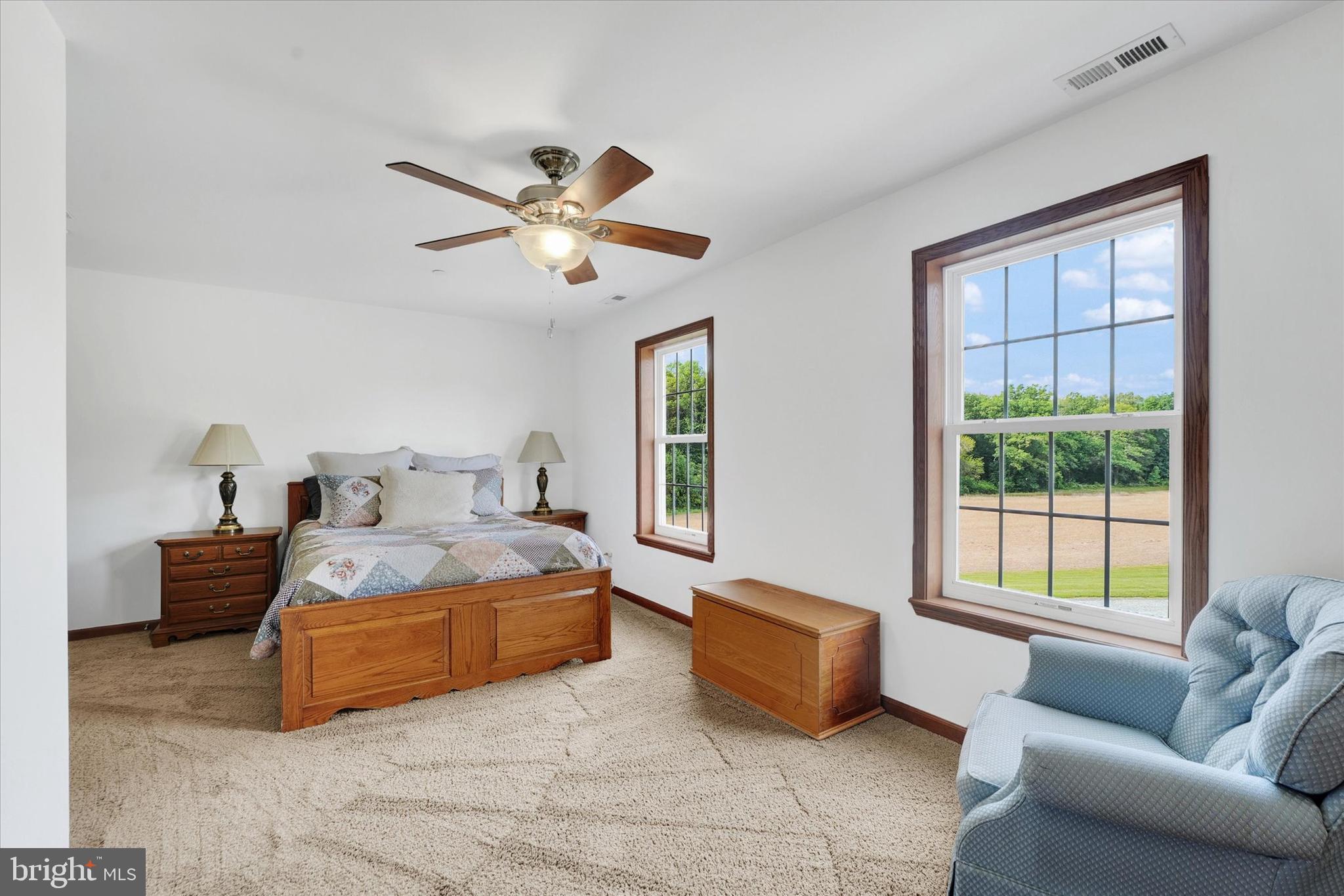 249 Floral Way Rising Sun, MD 21911 - Photo 41 of 65 a spacious bedroom with a bed a couch and a window