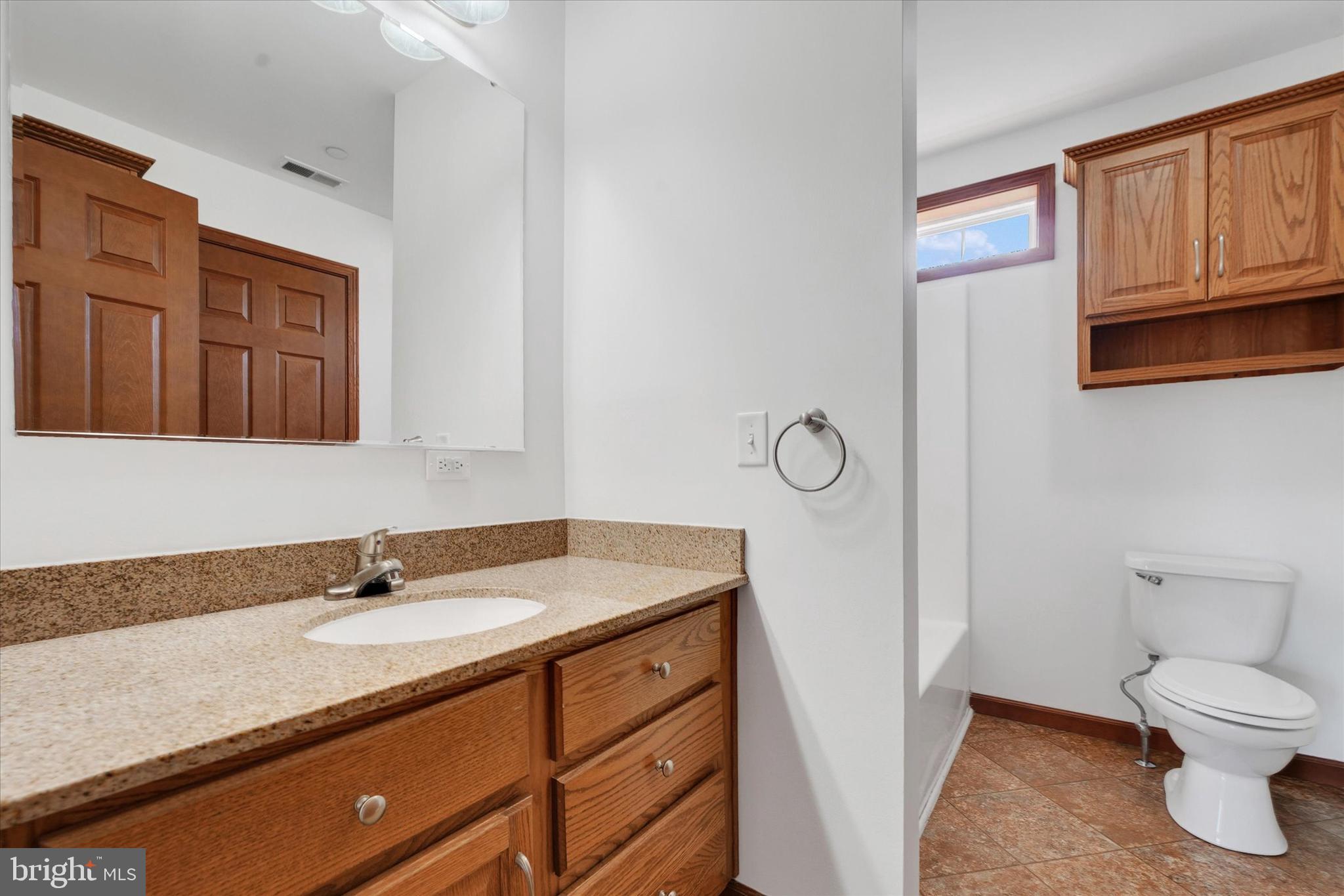249 Floral Way Rising Sun, MD 21911 - Photo 46 of 65 a bathroom with a granite countertop sink toilet and mirror