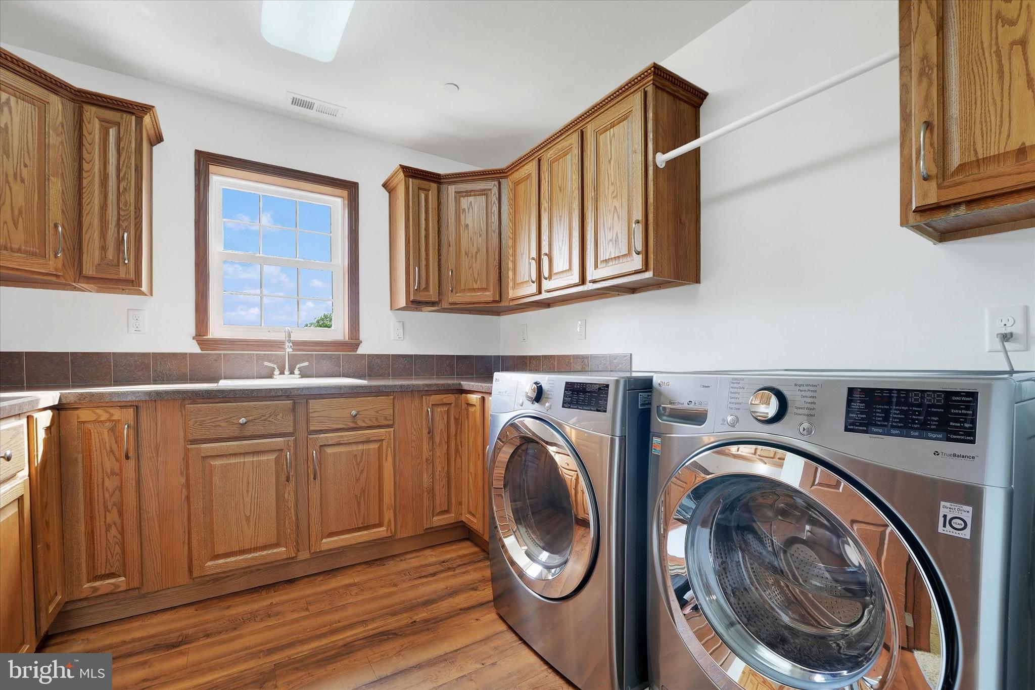 249 Floral Way Rising Sun, MD 21911 - Photo 57 of 65 a utility room with sink dryer and washer