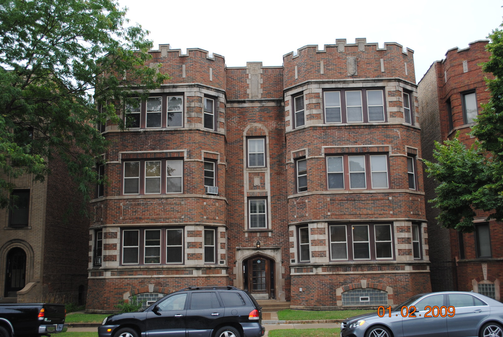 a front view of a residential apartment building with a yard