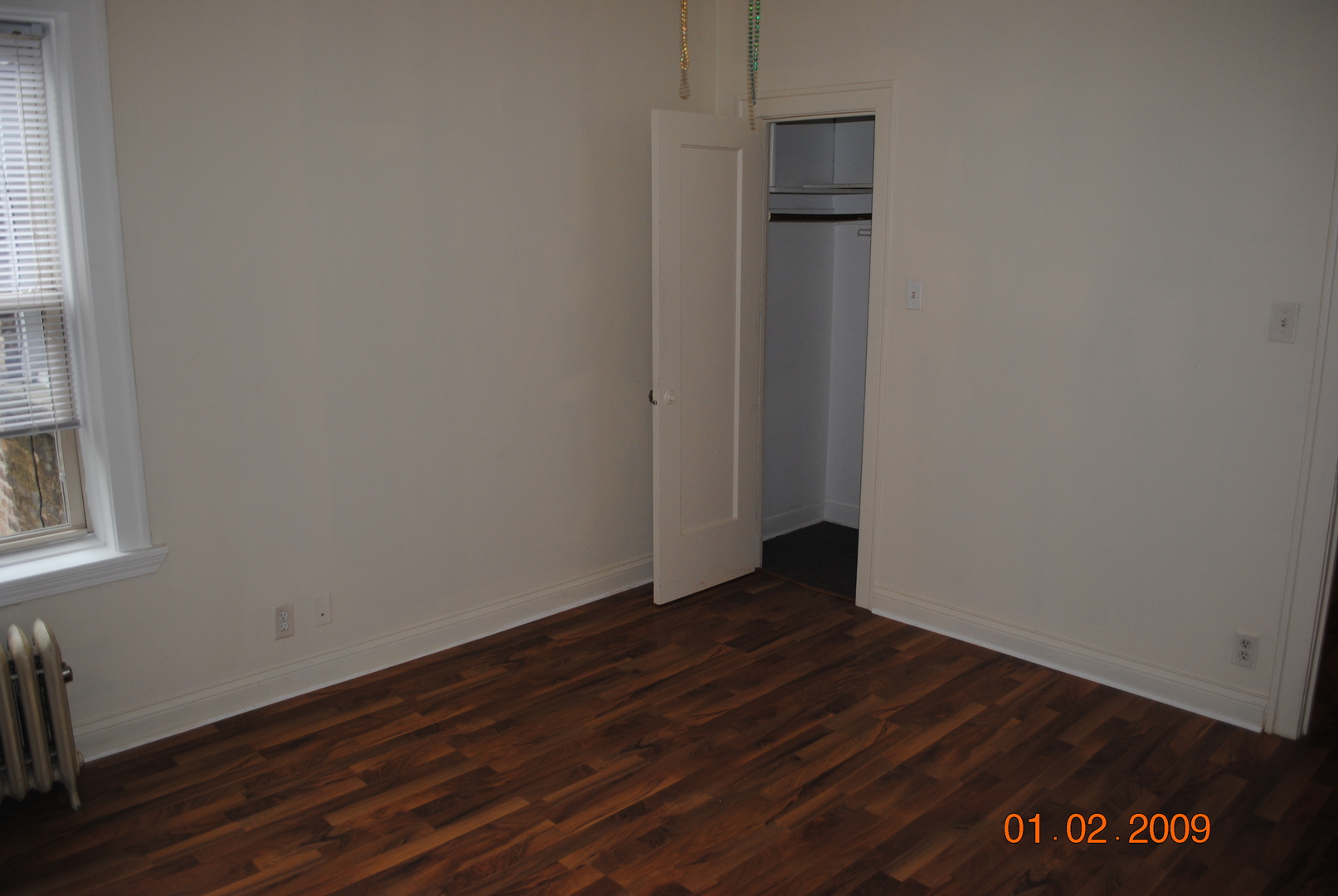 7635 South Yates Boulevard Chicago, IL 60649 - Photo 13 of 17 a view of an empty room with wooden floor and a window