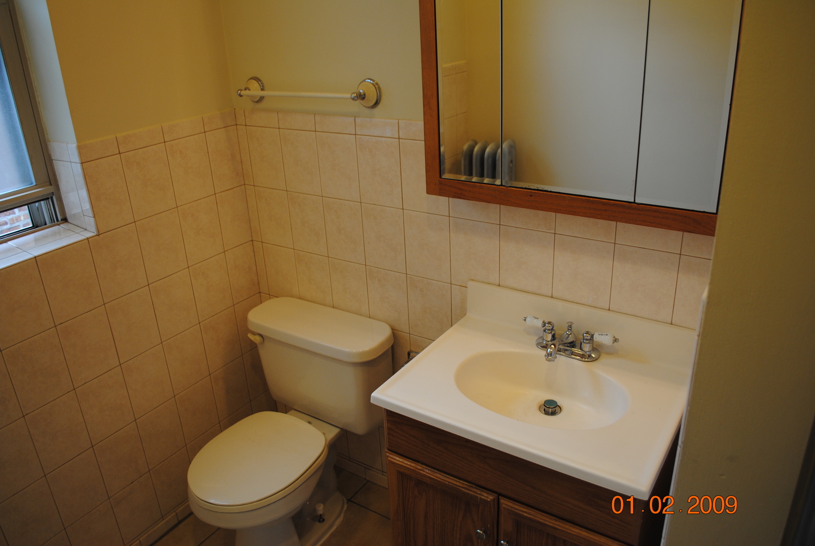 7635 South Yates Boulevard Chicago, IL 60649 - Photo 15 of 17 a bathroom with a sink a toilet and a mirror