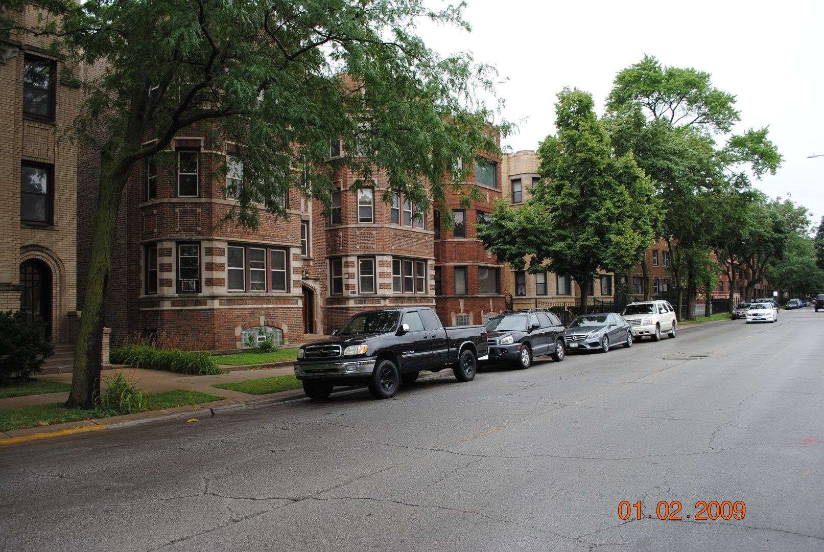 7635 South Yates Boulevard Chicago, IL 60649 - Photo 3 of 17 a car parked in front of a brick house